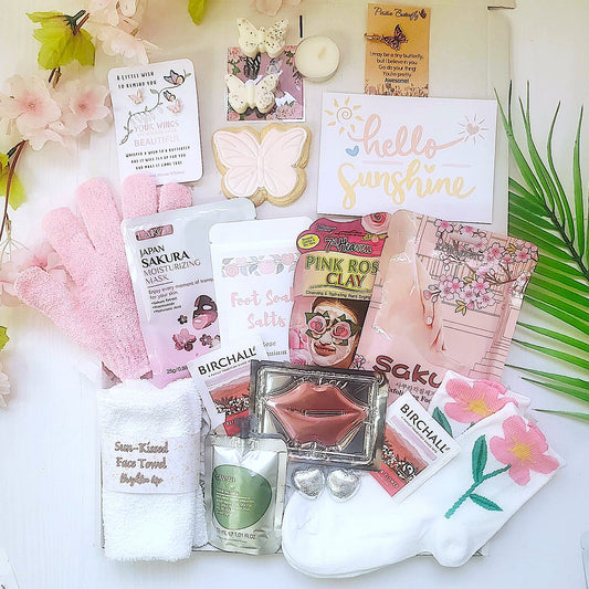 Collection of beauty products including face masks and facial items on a white surface with decorative elements.