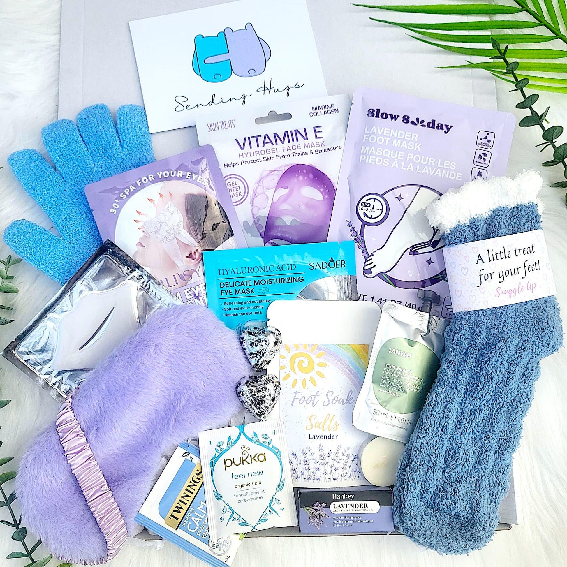 self care gift box with socks, exfoliating glove face mask, foot soak salt, foot mask, lavender theme, sleep mask, steam eye mask. complete spa gift set